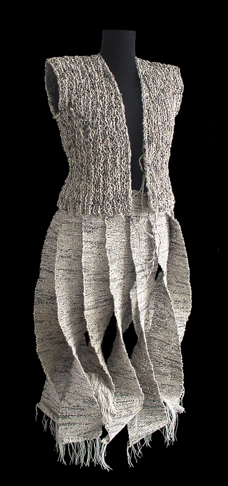 Skirt (2003) woven with an African loom: warp in white cotton and weft in newspaper. Knitted open waistcoat (2003).