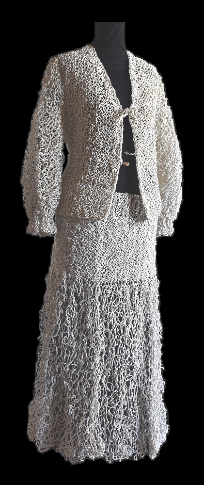 Dress made of the white parts of  newspapers. Composed of jacket (2007) and long transparent skirt (2009).